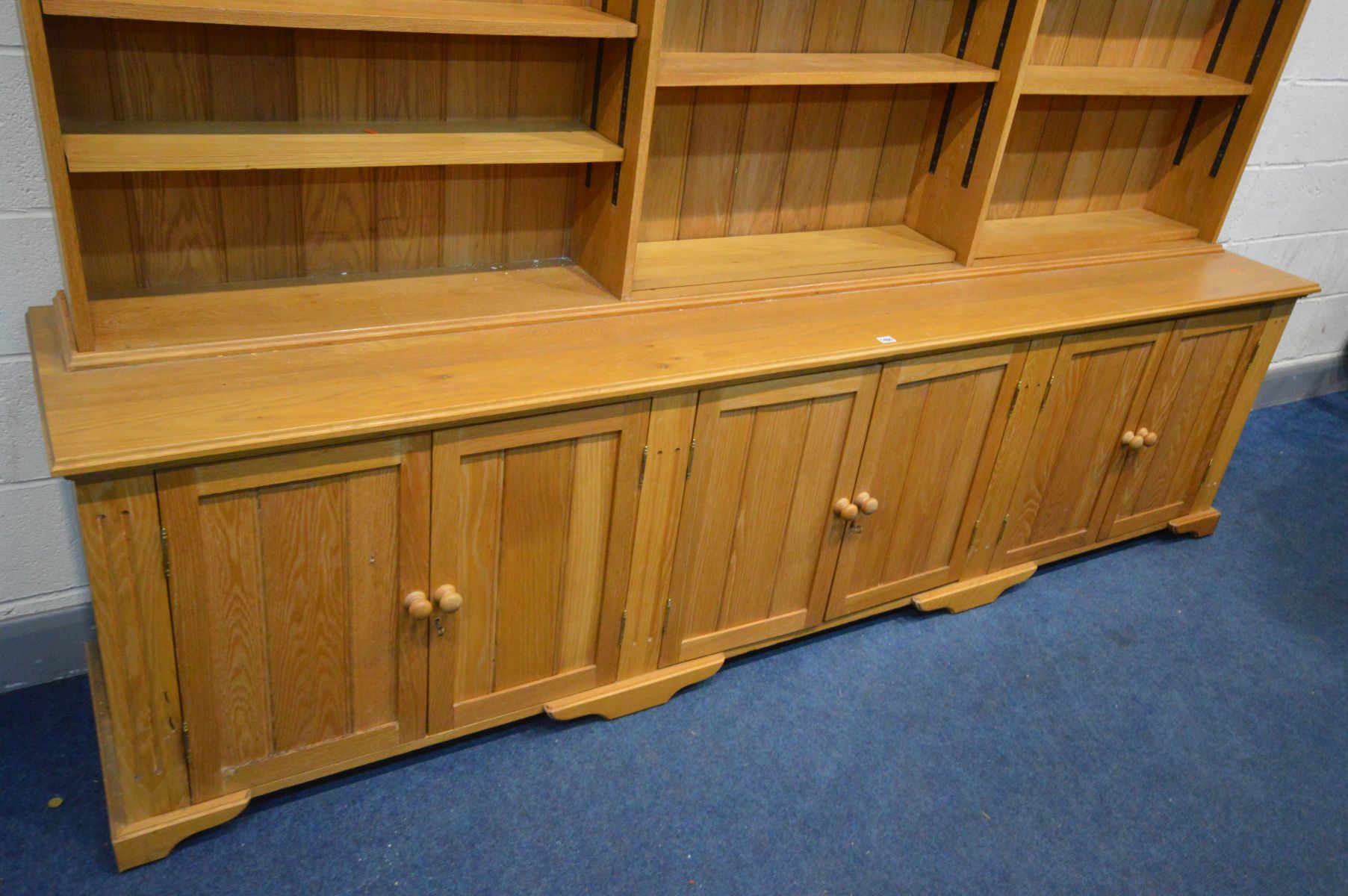 A LARGE LIMED OAK BOOKCASE, the three division top section with twelve adjustable shelves, above - Image 3 of 3