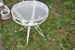 A WHITE PAINTED WROUGHT IRON GARDEN TABLE with a glass top 62cm in diameter