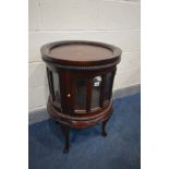 A HARDWOOD SINGLE DOOR CYLINDRICAL DRINKS TABLE/CABINET, on cabriole legs, diameter 51cm x height