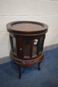 A HARDWOOD SINGLE DOOR CYLINDRICAL DRINKS TABLE/CABINET, on cabriole legs, diameter 51cm x height