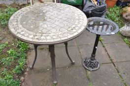 A METAL BASES GARDEN TABLE with a 76cm diameter tiled top and a cast iron bird bath82cm high (2)