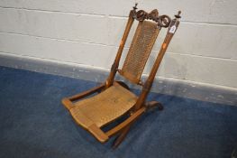 A 19TH CENTURY WALNUT ECCLESIASTICAL FOLDING CAMPAIGN CHAIR, with a rush seat and back