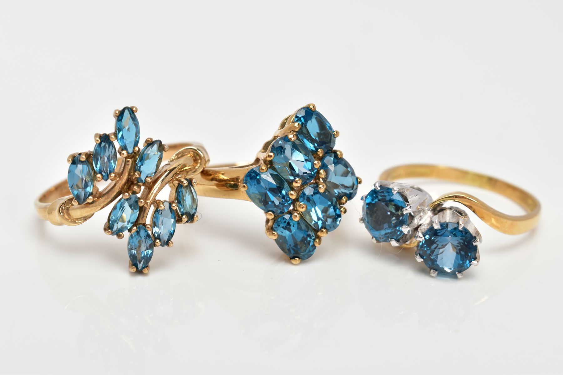 THREE TOPAZ DRESS RINGS, the first of a crossover style, set with two circular cut blue topaz, - Image 2 of 3