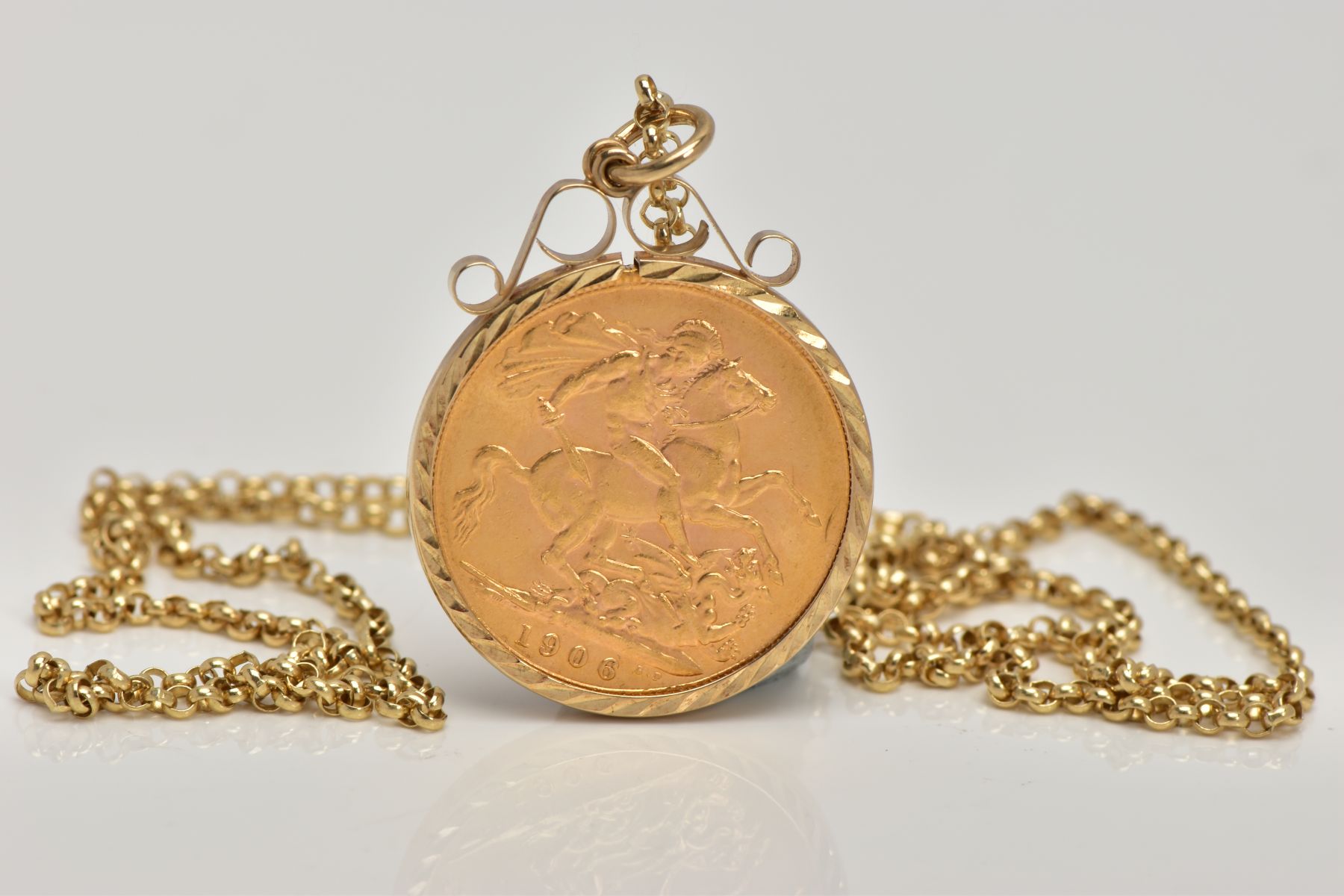 A SOVEREIGN PENDANT AND CHAIN, the 1906 Edward VII sovereign within a 9ct scrolling mount