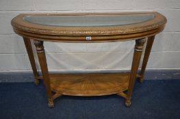 A FRENCH DEMI LUNE HALL TABLE, with a glass insert, on fluted legs, united by an undershelf, width