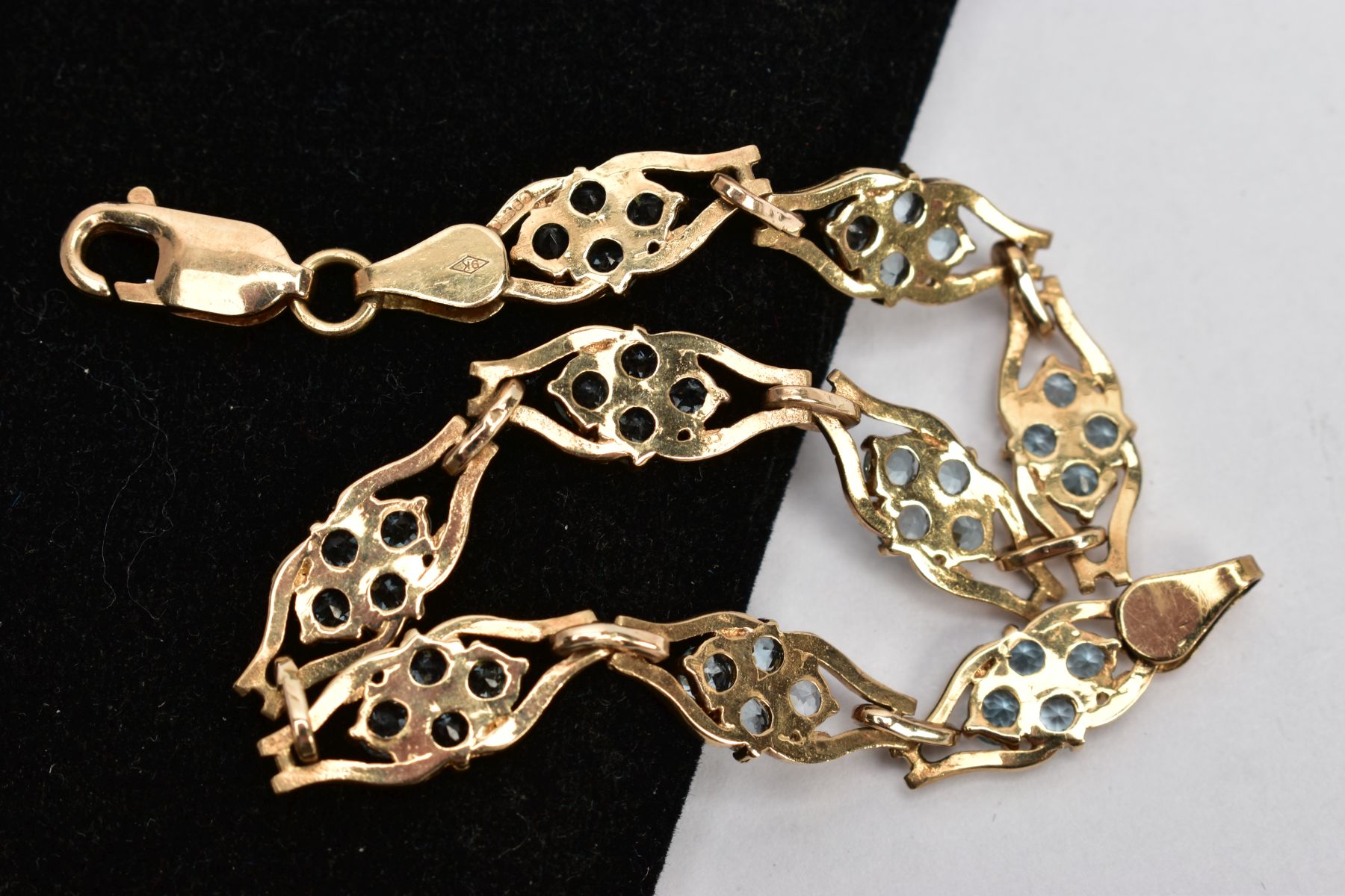 A 9CT GOLD TOPAZ LINE BRACELET, designed with nine openwork links, each set with four circular cut - Image 3 of 3