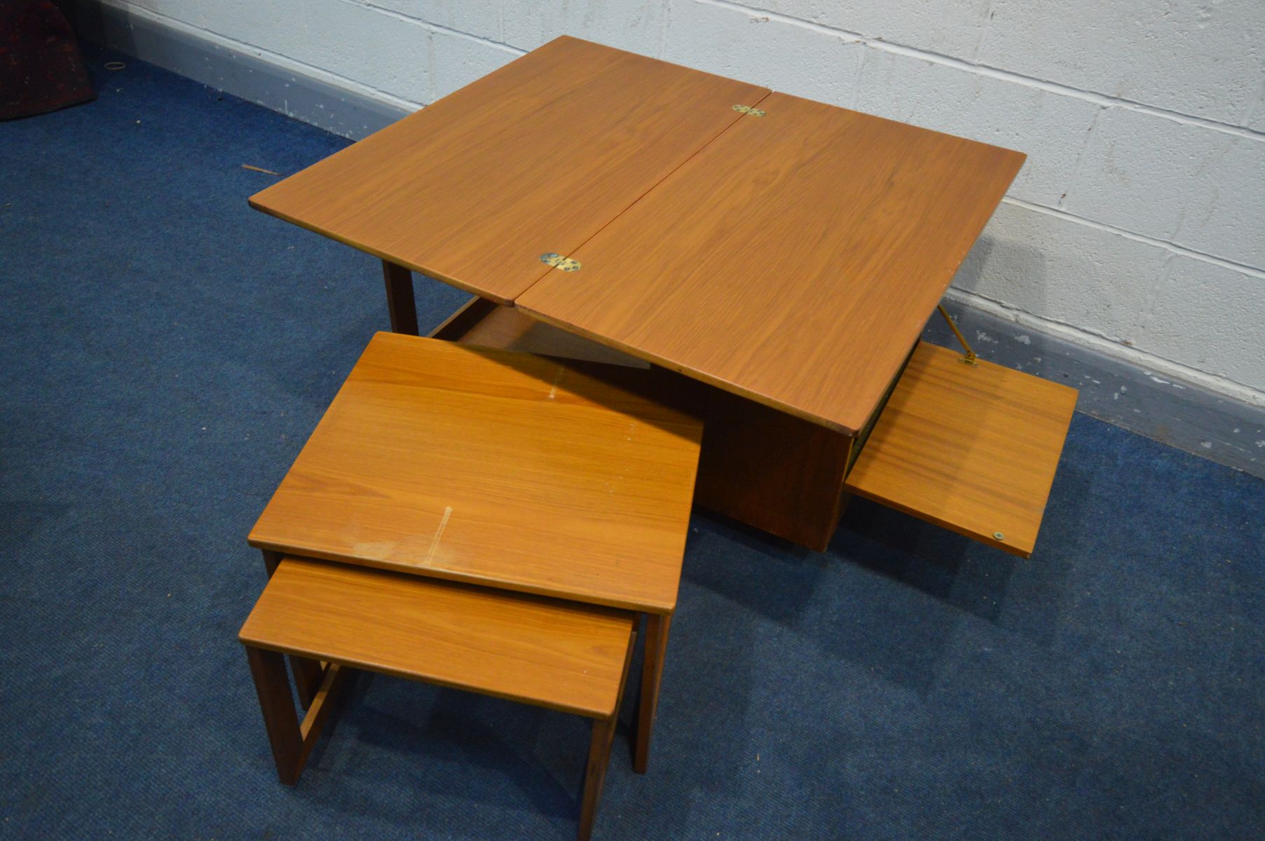 A TEAK COFFEE TABLE, with a rotating and fold over top, nest of two tables stored below and a fall - Image 4 of 4