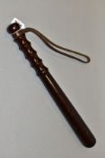 A WOODEN TRUNCHEON, stamped J Hudson & Co Birmingham, with some marking and wear, leather wrist