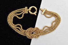A 9CT GOLD KNOT BRACELET, four chains formed into a central knot, fitted with a large spring