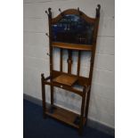 AN ARTS AND CRAFTS OAK HALL STAND, with eight hooks, and a bevelled edge mirror, width 76cm x