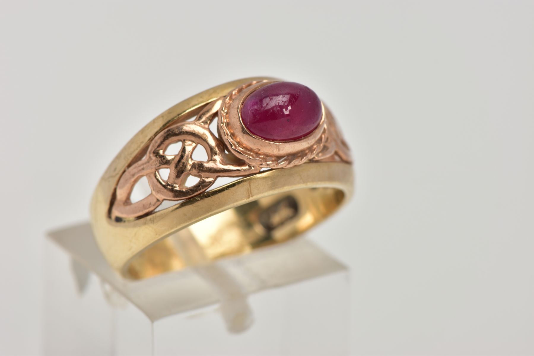 A 9CT GOLD 'CLOGAU' SIGNET RING, designed with a central oval ruby cabochon, collet mount with a - Image 4 of 5