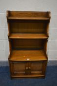 AN ERCOL GOLDEN DAWN WATERFALL OPEN BOOKCASE, with double cupboard doors, width 61cm x depth 35cm