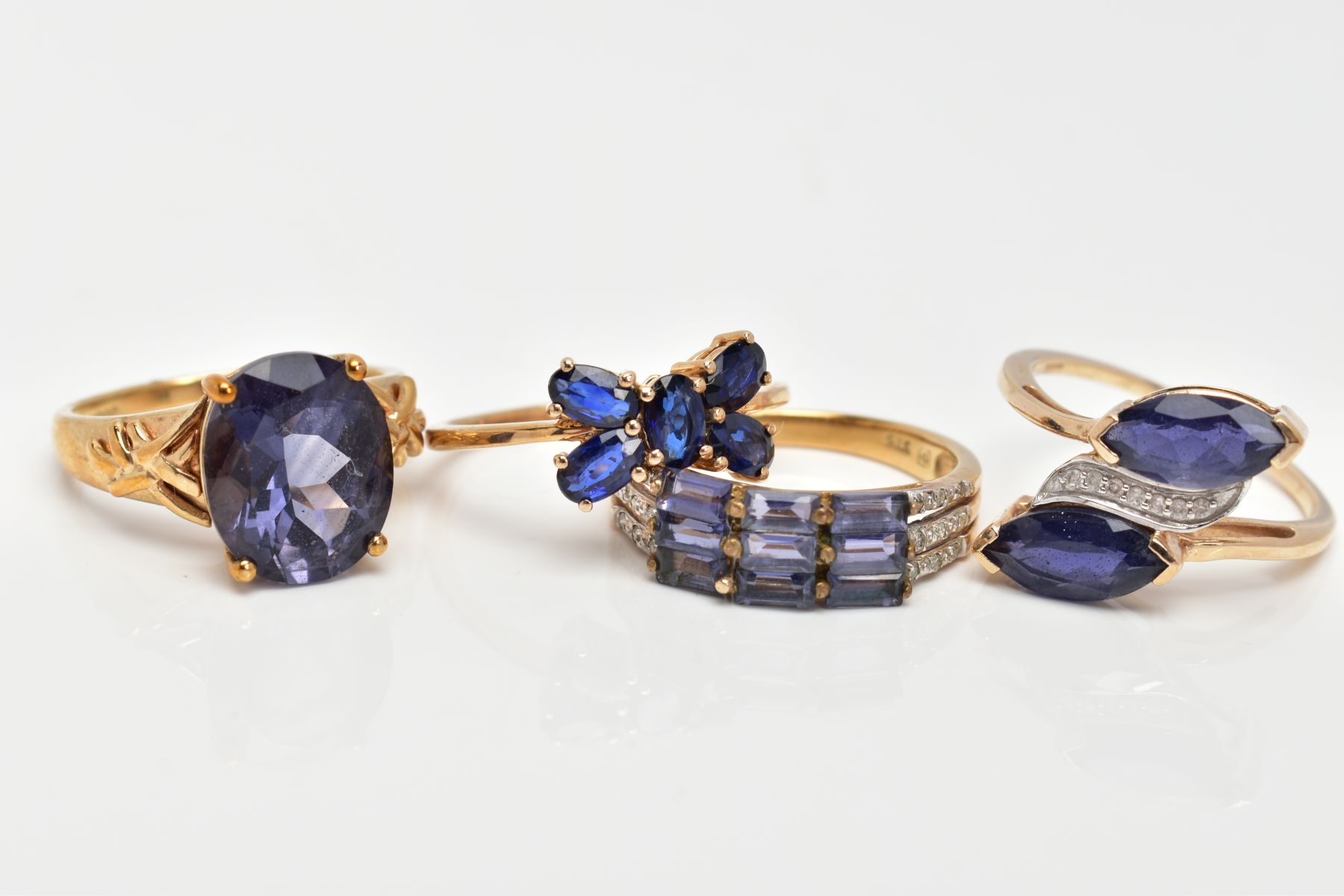 FOUR 9CT GOLD GEM SET DRESS RINGS, various designs and set with vary cut gemstones to include