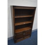 A OLD CHARM OAK OPEN BOOKCASE, with double linenfold cupboard doors, width 92cm x depth 32cm x