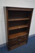 A OLD CHARM OAK OPEN BOOKCASE, with double linenfold cupboard doors, width 92cm x depth 32cm x