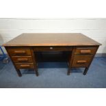 AN 1940'S OAK DESK, with an arrangement of six drawers, width 153cm x depth 76cm x height 78cm -