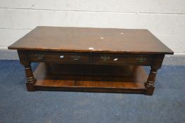 AN OAK WILLIS AND GAMBIER STYLE COFFEE TABLE with two drawers, undershelf and turned supports, width