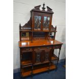 AN EDWARDIAN WALNUT DISPLAY CABINET, with an arrangement of mirrors, drawers and cupboard doors,