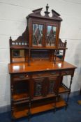 AN EDWARDIAN WALNUT DISPLAY CABINET, with an arrangement of mirrors, drawers and cupboard doors,