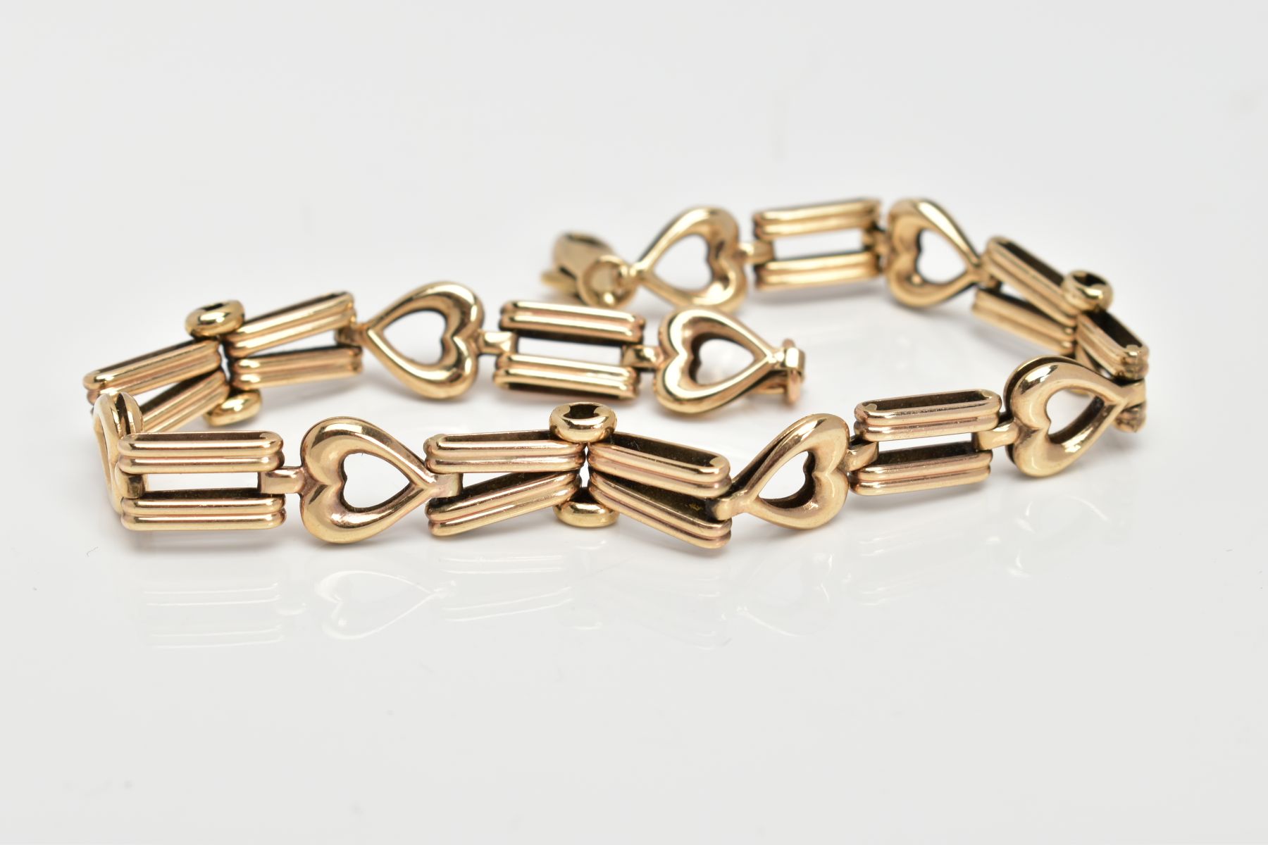 A 9CT GOLD BRACELET, designed with textured tapered links interspaced with openwork heart links, - Image 2 of 2