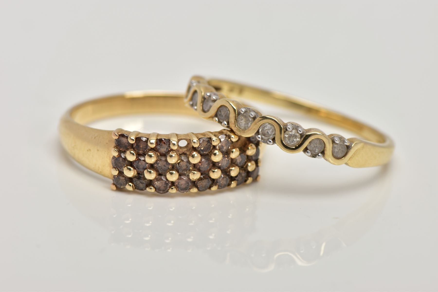 TWO 9CT GOLD DIAMOND SET RINGS, the first a half eternity ring set with a row of single cut