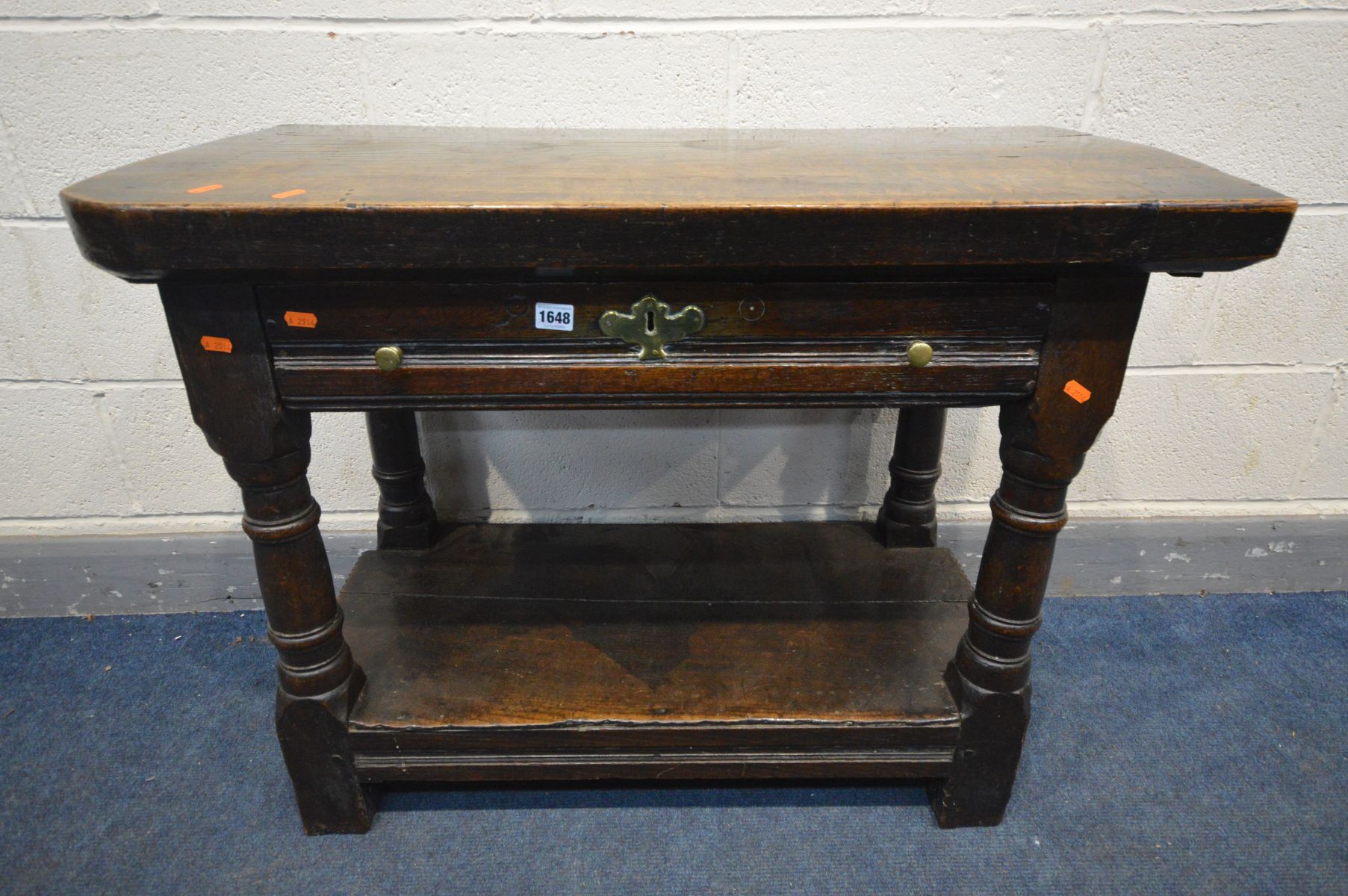 A GEORGE I WELSH OAK SIDE TABLE, the later plank top above a long single drawer with a brass