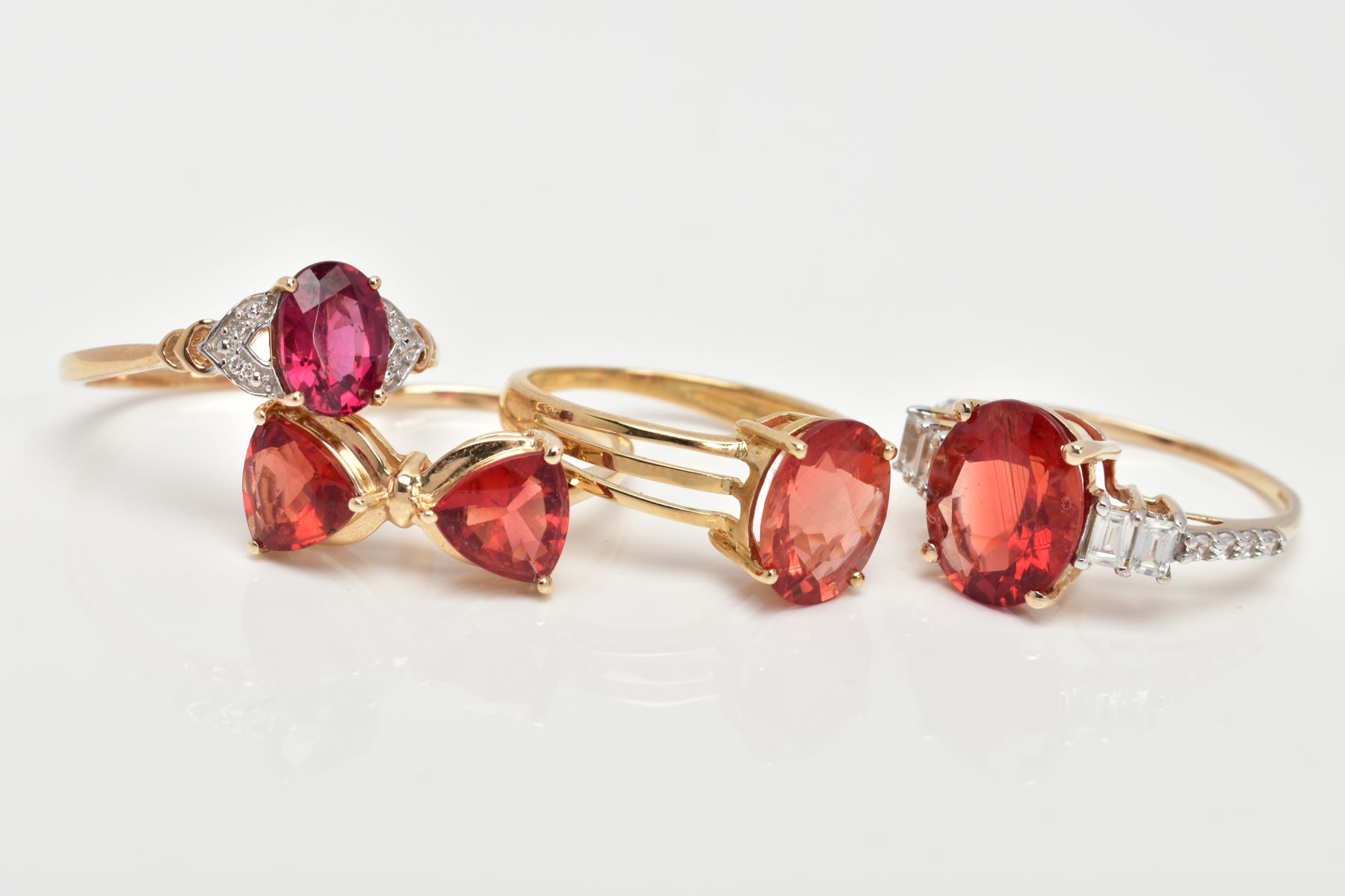 FOUR 9CT GOLD GEM SET RINGS, each set with orangish red stones, assessed as garnet and Oregan - Image 2 of 3