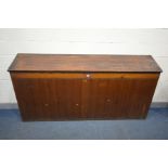 AN EARLY 20TH CENTURY PITCH PINE AND PANELLED FRONTED SLOPPED TOP SIDE STORAGE CABINET, with a