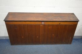 AN EARLY 20TH CENTURY PITCH PINE AND PANELLED FRONTED SLOPPED TOP SIDE STORAGE CABINET, with a