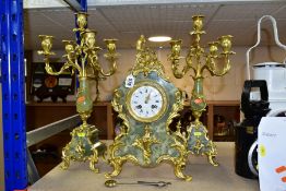 A FRENCH ONYX AND GILT METAL CLOCK GARNITURE, the enamel dial having Roman numeral hours and