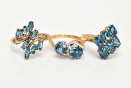 THREE TOPAZ DRESS RINGS, the first of a crossover style, set with two circular cut blue topaz,