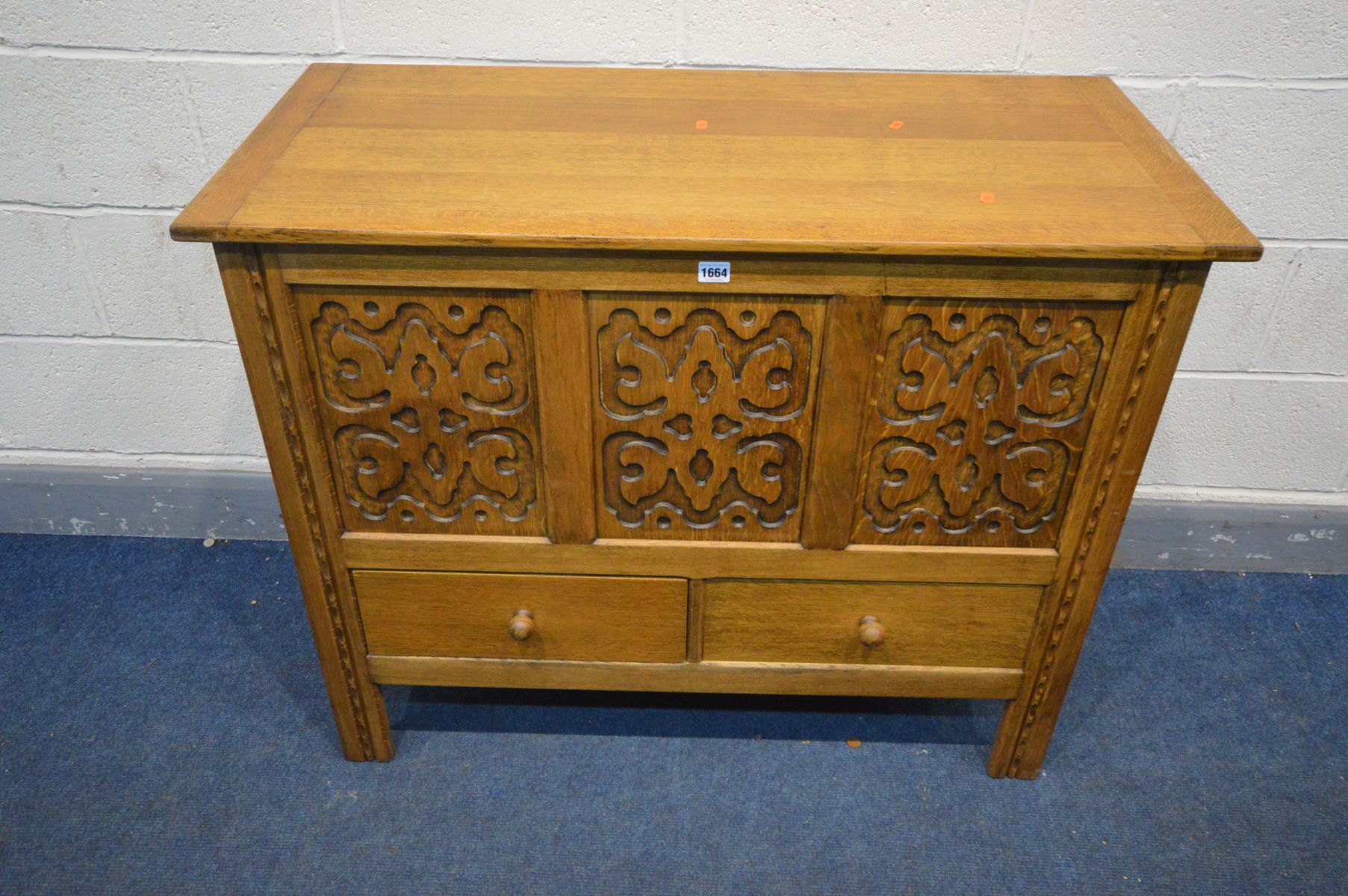 A 'HEATHLAND FURNITURE' OAK MULE CHEST, with blind fretwork detailing to the three front panels