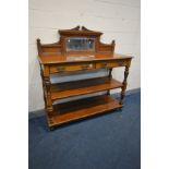 A LATE VICTORIAN OAK THREE TIER BUFFET, having a raised bevelled mirror back, two frieze drawers,