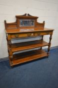 A LATE VICTORIAN OAK THREE TIER BUFFET, having a raised bevelled mirror back, two frieze drawers,