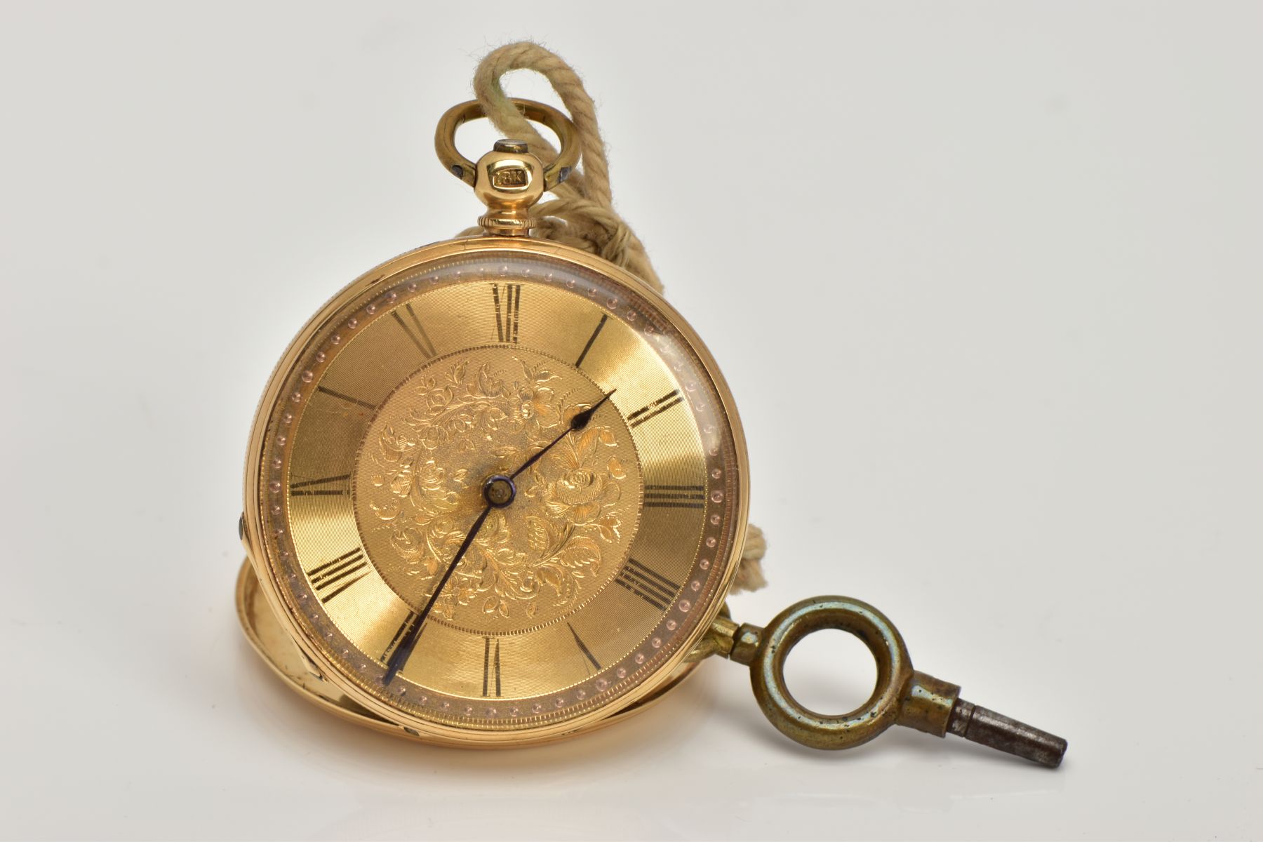 A YELLOW METAL OPEN FACE POCKET WATCH, round gold dial, with a floral engraved design, Roman