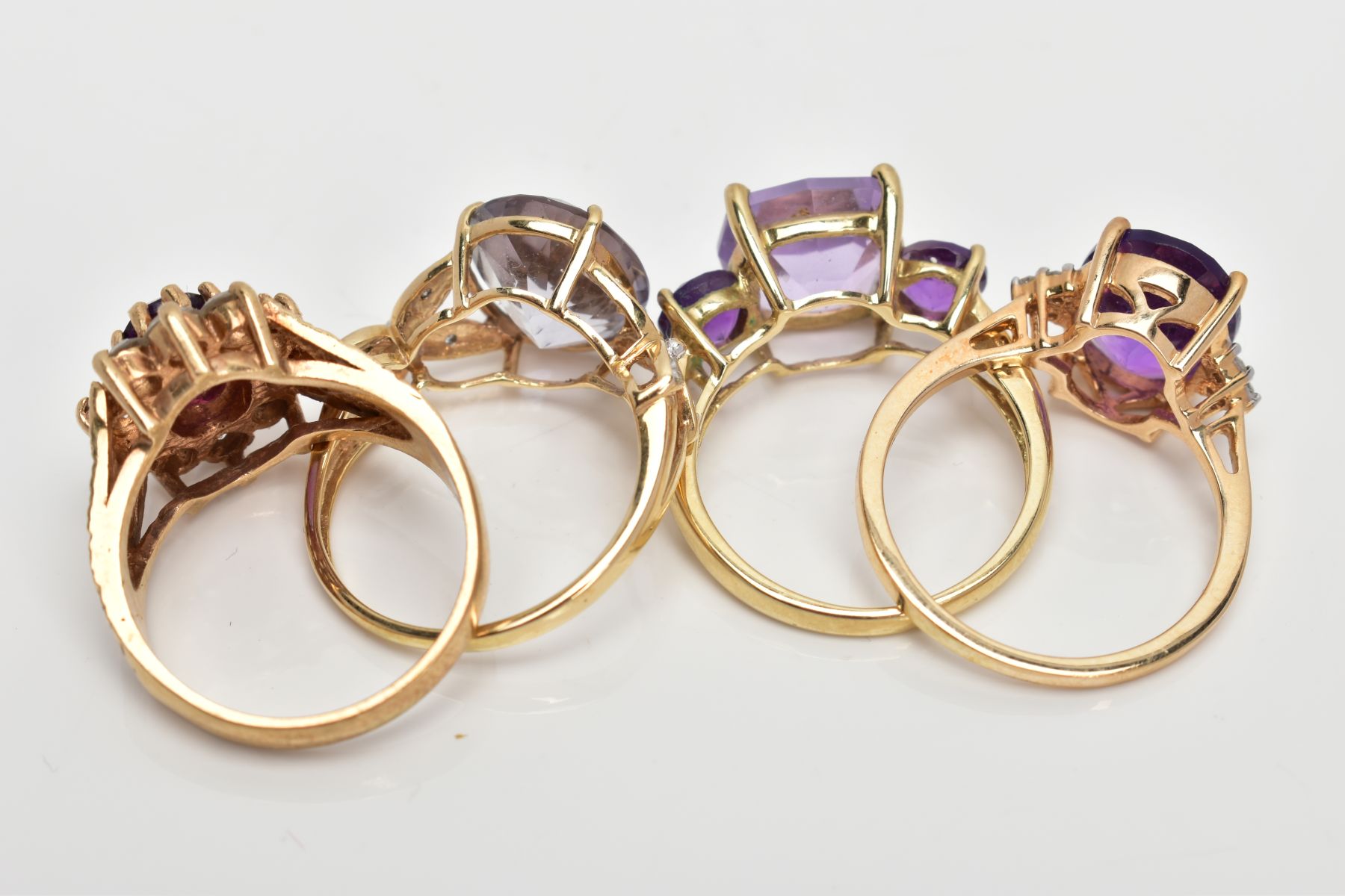 FOUR AMETHYST DRESS RINGS, two set with oval cut amethysts with single cut diamond detailed - Image 3 of 3