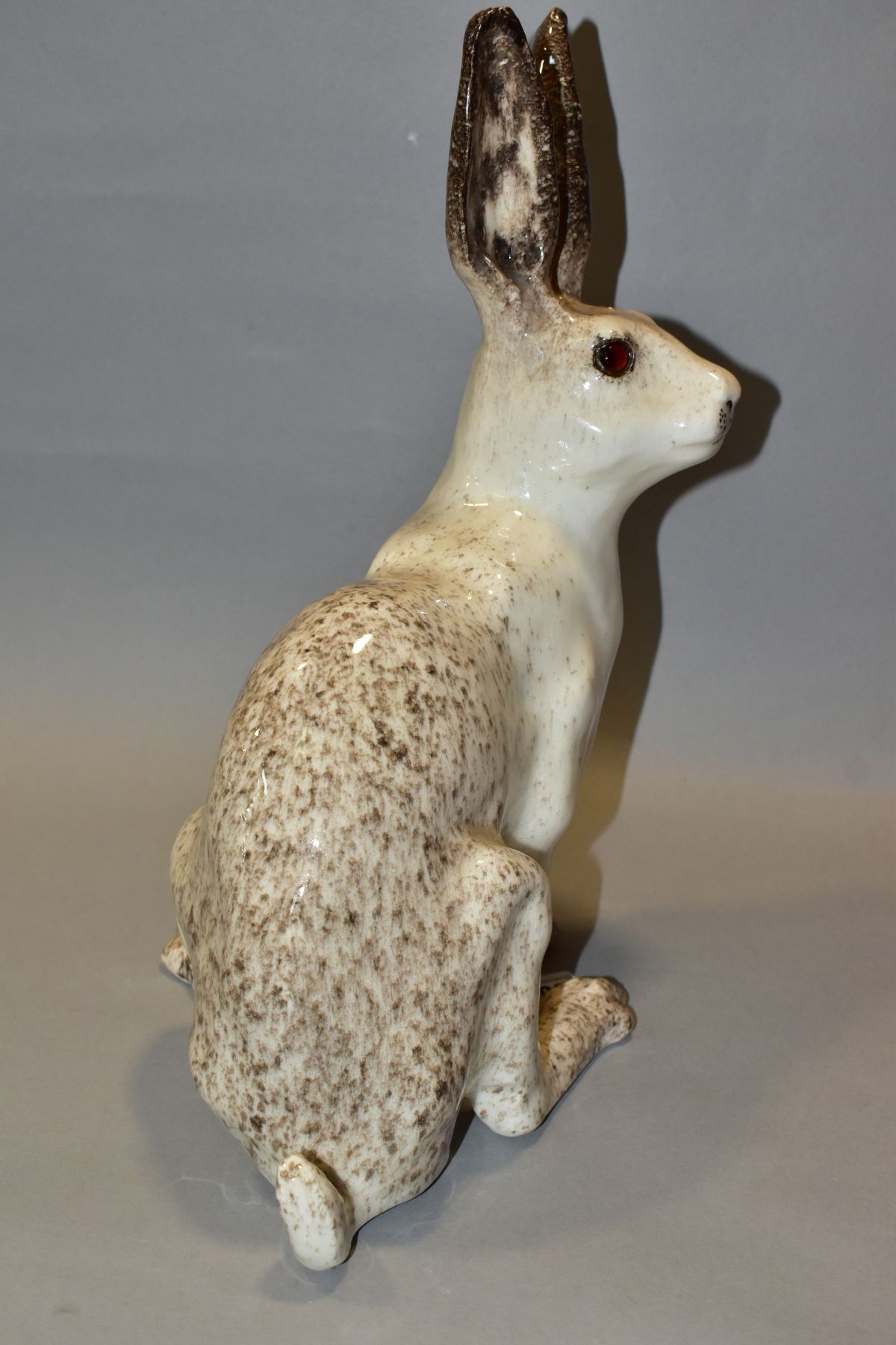 A WINSTANLEY POTTERY CREAM AND MOTTLED BROWN FIGURE OF A SEATED HARE, glass eyes, painted marks to - Image 3 of 5