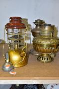 FOUR OIL LAMPS, comprising a Tilley lamp marked 'Model X246A', two brass oil lamps, one marked 'Made