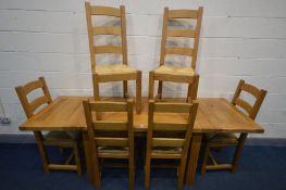 A LIGHT SOLID OAK DINING TABLE, with a single drawer and two extending leaves, extended length 221cm