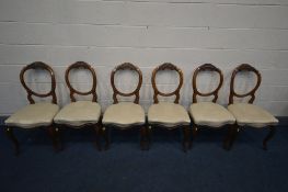 A SET OF SIX 19TH CENTURY WALNUT BALLOON BACK CHAIRS with florally carved top rail, on cabriole legs