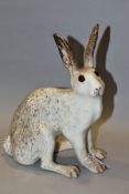 A WINSTANSLEY POTTERY CREAM AND MOTTLED BROWN FIGURE OF A SEATED HARE, glass eyes, painted marks