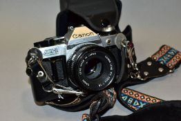 A CANON AE-1 PROGRAM 35MM SLR CAMERA, fitted with a Canon FD 50mm f1:8 lens complete with camera