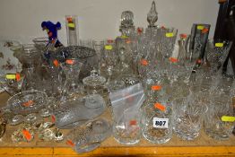 A COLLECTION OF DRINKING GLASSES, DECANTERS, VASES, PAPERWEIGHTS, ETC, a mixture of cut and