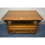 AN ERCOL GOLDEN DAWN TV STAND, with a corner drop leaf, and a single drawer, width 75cm x closed