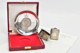 A SILVER ‘QUEEN MOTHER CROWN DISH’, NAPKIN RING AND A VESTA, the cased silver dish inset with a