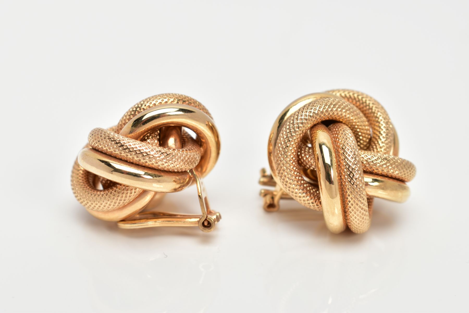 A PAIR OF YELLOW METAL KNOT EARRINGS, textured and non-textured intertwined knots, fitted with non- - Image 3 of 3