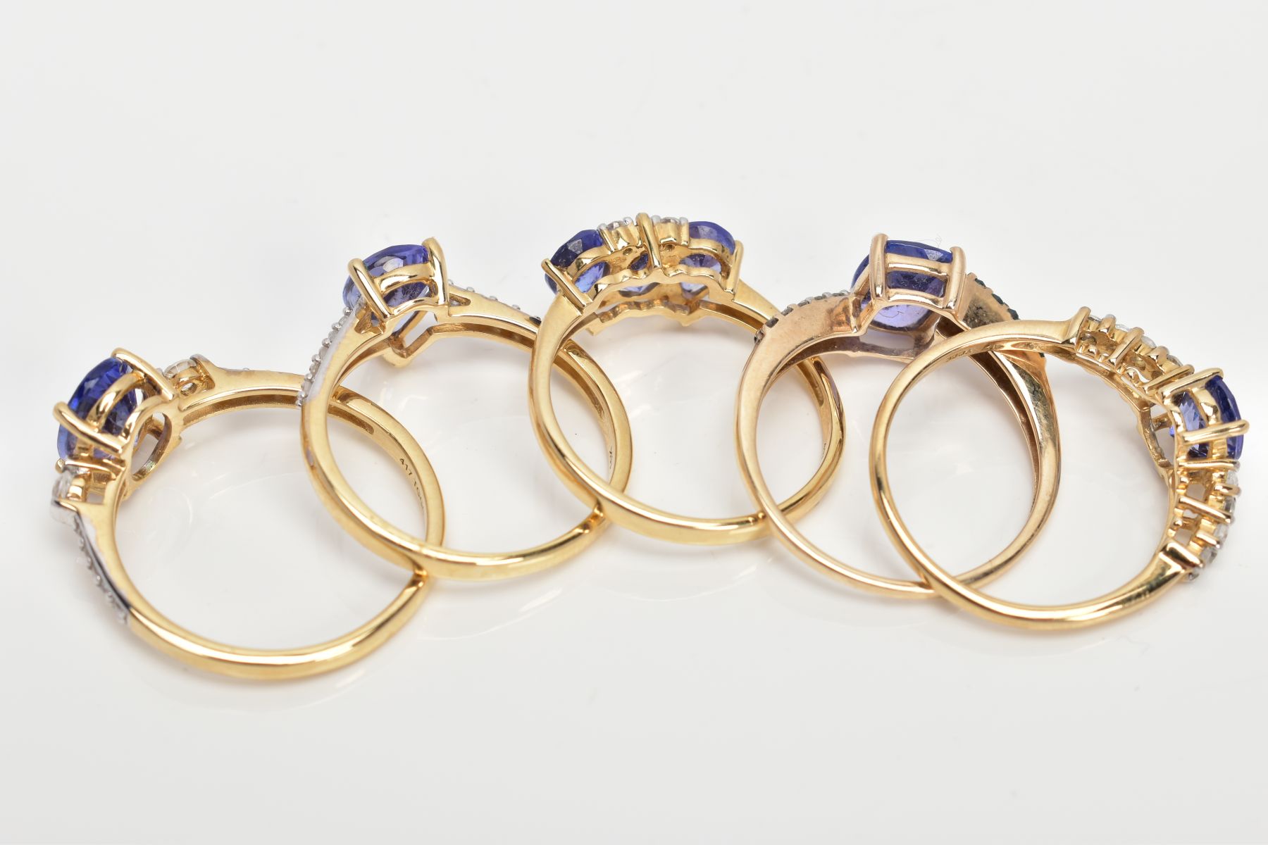 FIVE 9CT GOLD TANZANITE DRESS RINGS, vary cut tanzanite's, also flanked with either colourless - Image 3 of 3