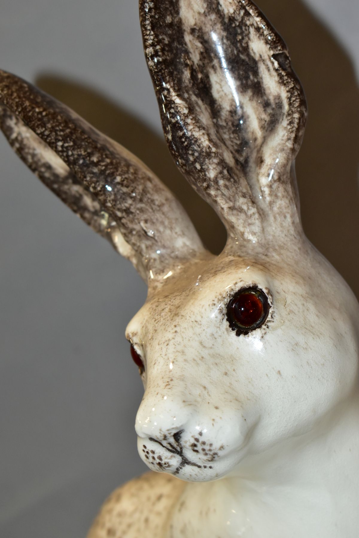 A WINSTANLEY POTTERY CREAM AND MOTTLED BROWN FIGURE OF A SEATED HARE, glass eyes, painted marks to - Image 2 of 5