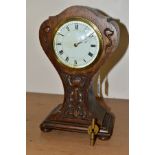 AN OAK ARTS AND CRAFTS CARVED BALLOON CASED MANTEL CLOCK, white enamel dial (s.d.), with Roman and