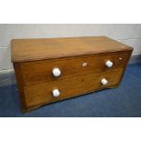 A LOW OAK CHEST OF TWO DRAWERS, with ceramic handles, width 100cm x depth 43cm x height 46cm